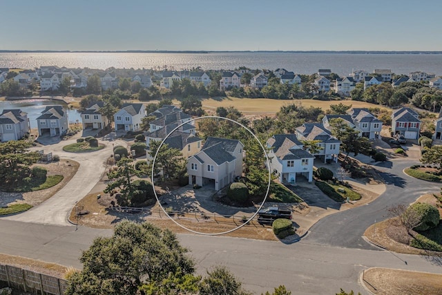 drone / aerial view featuring a water view and a residential view