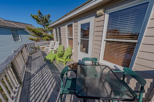 wooden terrace featuring outdoor dining space