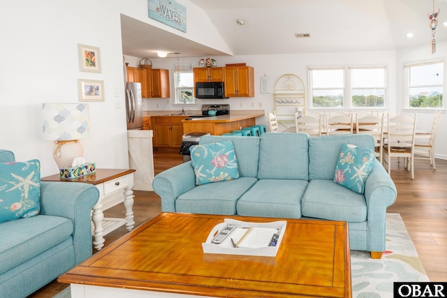 631 Skimmer Ct Lot 17, Corolla, NC 27927 - living area with healthy amount of natural light, lofted ceiling, light wood-style floors, and recessed lighting