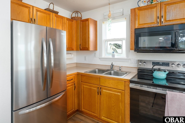 631 Skimmer Ct Lot 17, Corolla, NC 27927 - kitchen featuring stainless steel appliances, light countertops, brown cabinets, and pendant lighting