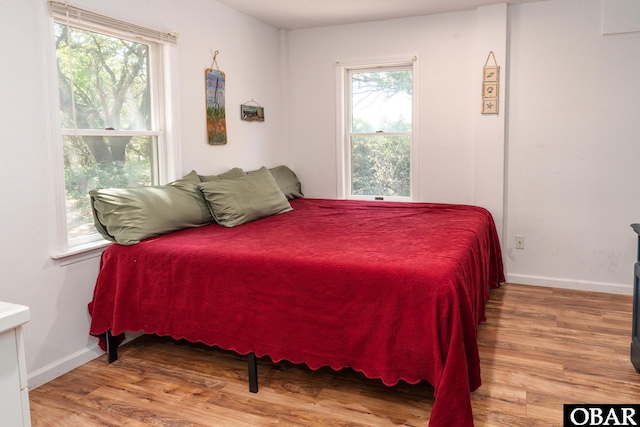 631 Skimmer Ct Lot 17, Corolla, NC 27927 - bedroom with wood finished floors and multiple windows