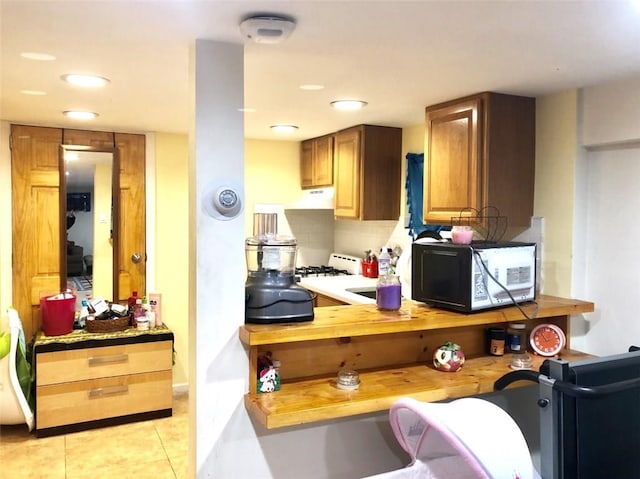 kitchen with light tile patterned floors and backsplash