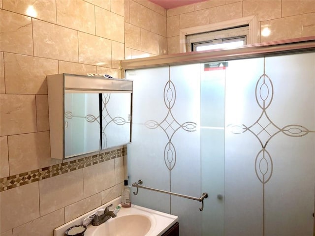 bathroom with tile walls, vanity, and tasteful backsplash