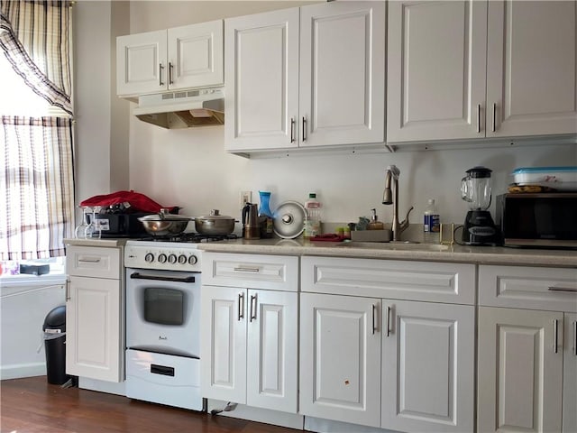 kitchen featuring gas range, sink, dark wood-type flooring, and white cabinets