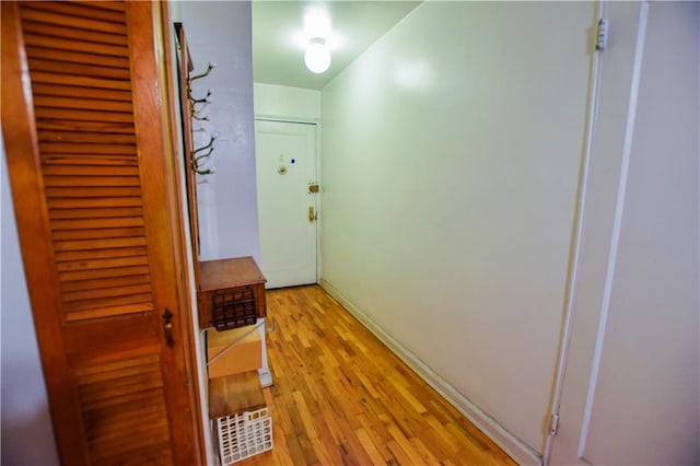 doorway to outside featuring light wood finished floors and baseboards