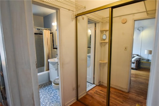 full bath featuring vanity, shower / tub combo, wood finished floors, and toilet