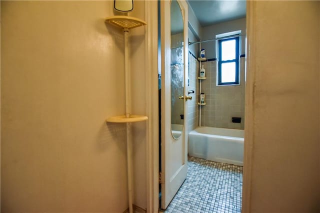 full bathroom with shower / washtub combination and tile patterned flooring