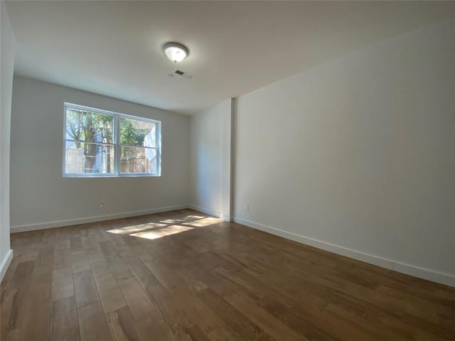 empty room with hardwood / wood-style flooring