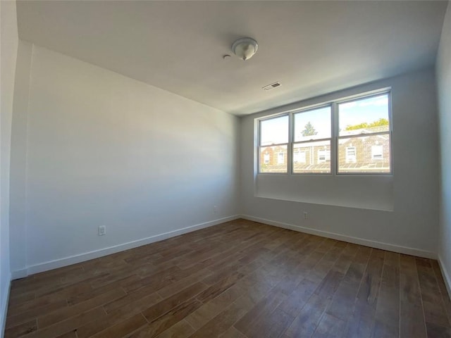 empty room featuring dark hardwood / wood-style floors