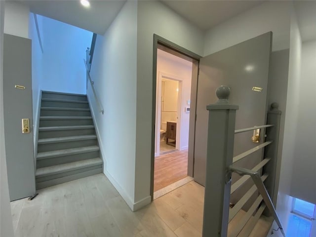 stairway featuring hardwood / wood-style flooring