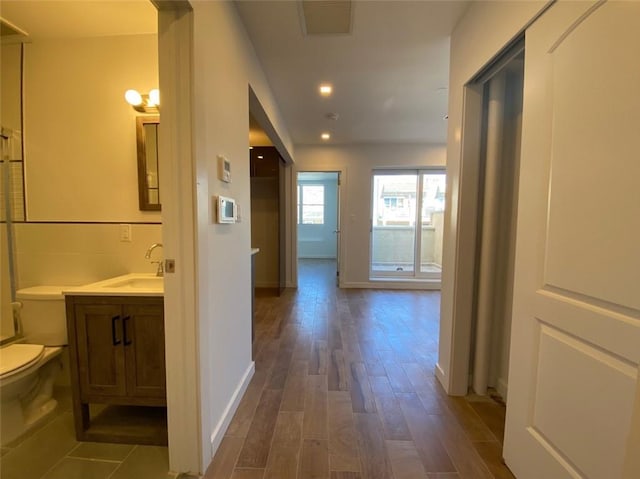 hall with dark wood-type flooring and sink