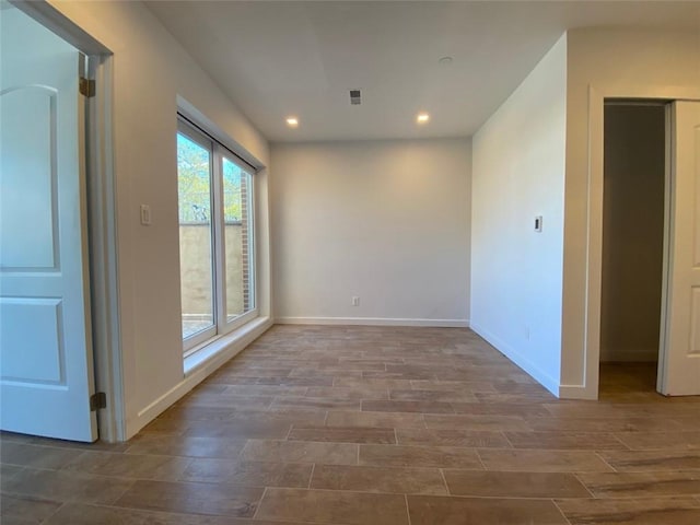 unfurnished room featuring hardwood / wood-style flooring