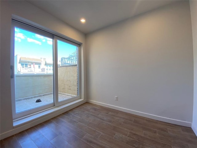 empty room featuring hardwood / wood-style flooring and a healthy amount of sunlight