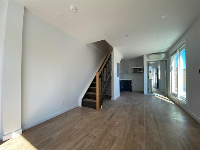 unfurnished living room featuring hardwood / wood-style flooring