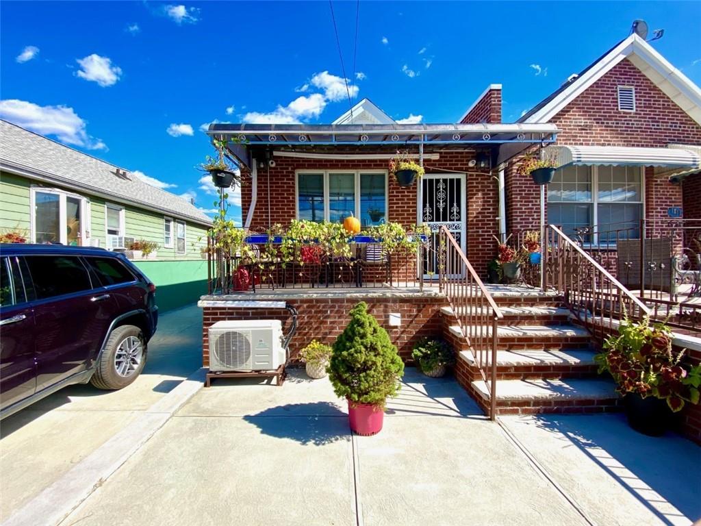 view of front of house featuring ac unit and covered porch