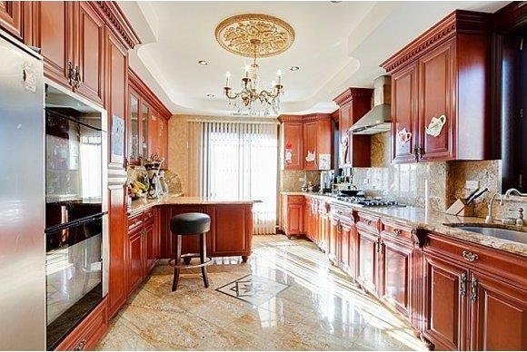 1366 70th St, Brooklyn, NY 11228 - kitchen featuring wall chimney range hood, a sink, stainless steel gas cooktop, decorative backsplash, and a chandelier