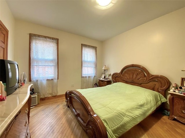 bedroom featuring multiple windows and light wood-type flooring