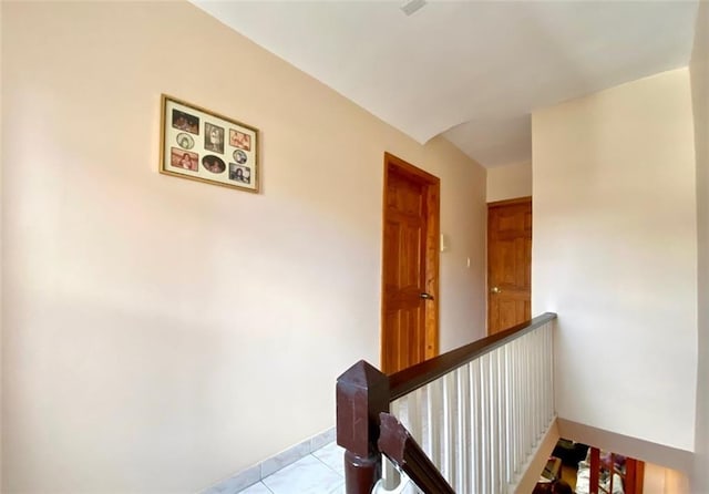 hall featuring light tile patterned floors