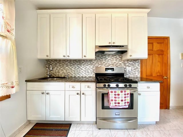 kitchen with gas stove, tasteful backsplash, and white cabinets