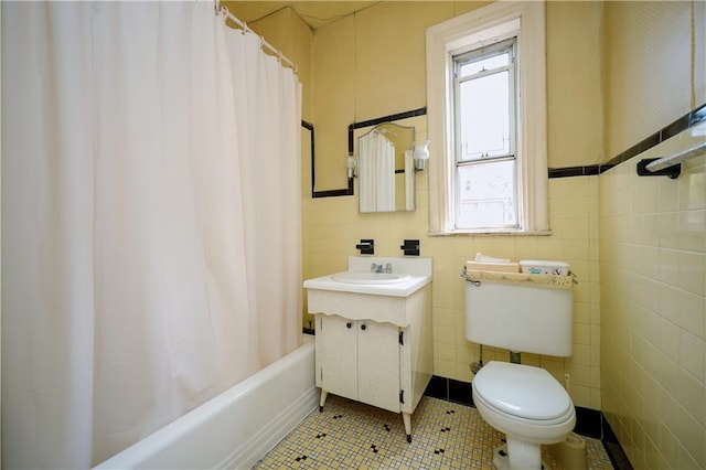 full bath featuring tile walls, toilet, shower / bath combo, vanity, and tile patterned flooring