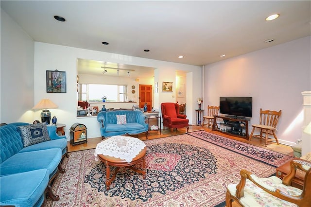 living area featuring recessed lighting, baseboards, and wood finished floors