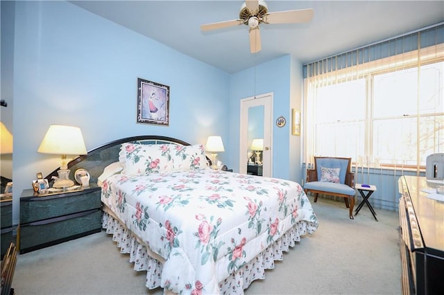 bedroom featuring a ceiling fan and carpet