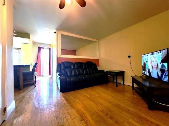 living room with ceiling fan and hardwood / wood-style flooring