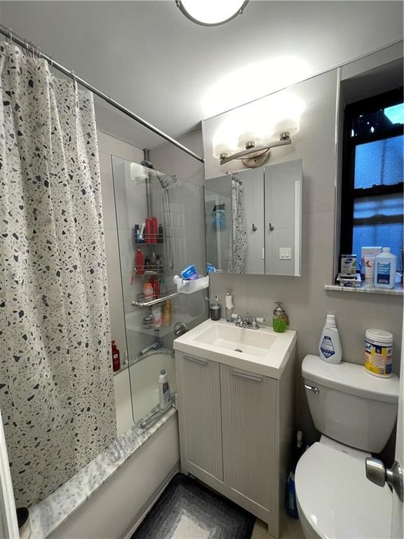 full bathroom featuring vanity, toilet, and shower / tub combo