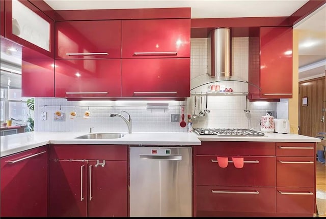 kitchen featuring wall chimney exhaust hood, decorative backsplash, sink, and appliances with stainless steel finishes