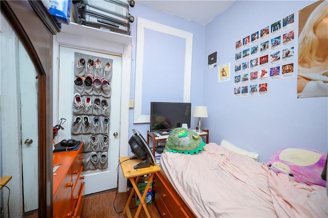 bedroom featuring a closet and dark hardwood / wood-style flooring