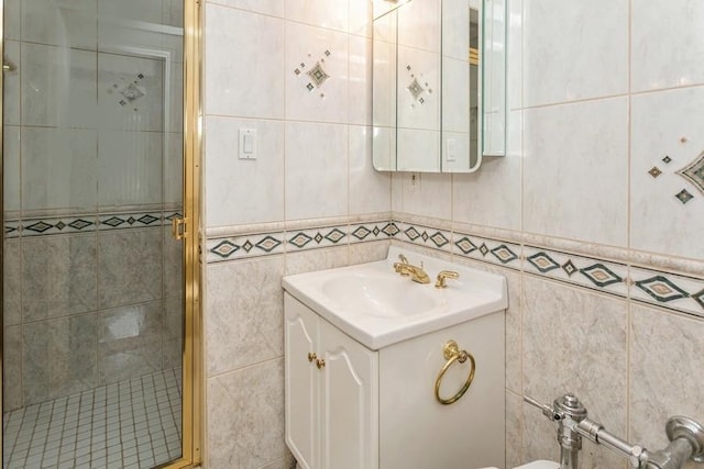 bathroom featuring tile walls, vanity, and a shower with door