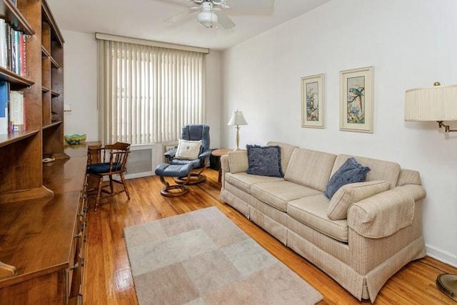 living room with ceiling fan and wood-type flooring