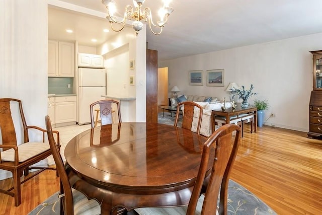 dining room featuring an inviting chandelier and light hardwood / wood-style floors