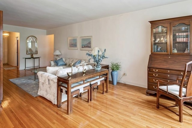 living room with a notable chandelier and light wood-type flooring