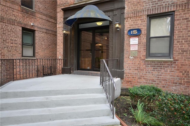 view of exterior entry with brick siding