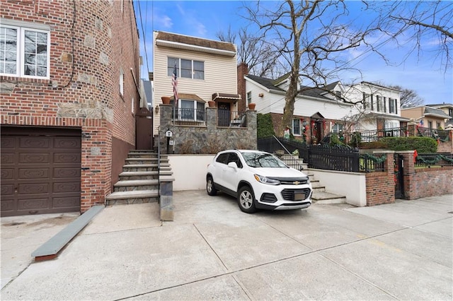 view of front of house with stairs and brick siding