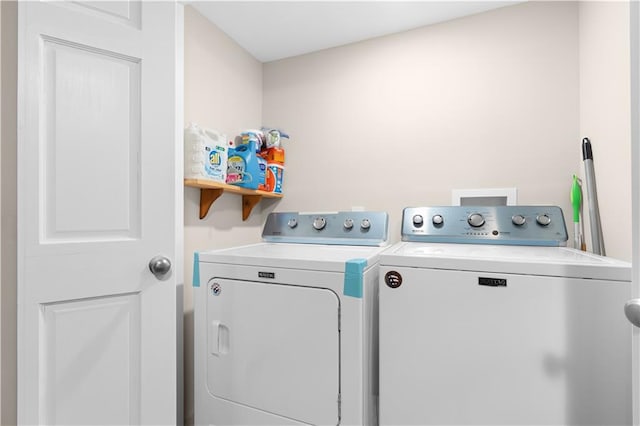 clothes washing area featuring laundry area and washing machine and clothes dryer