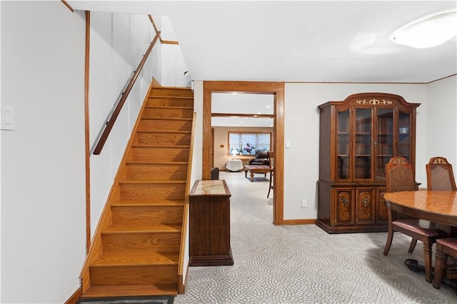 stairs featuring baseboards and carpet flooring