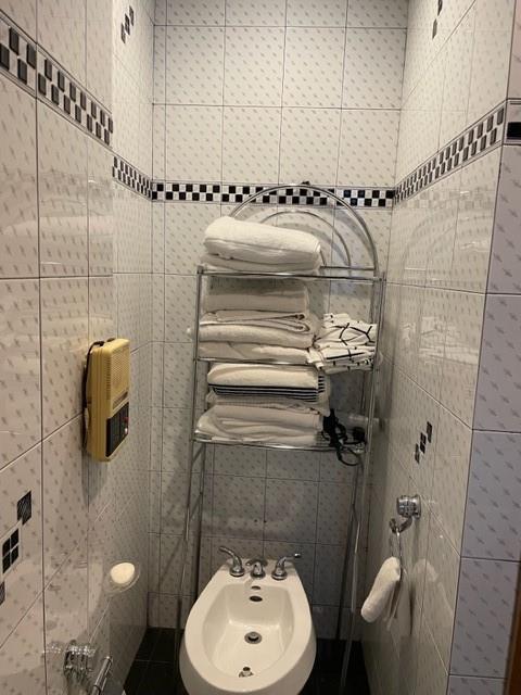 bathroom featuring a bidet and tile walls