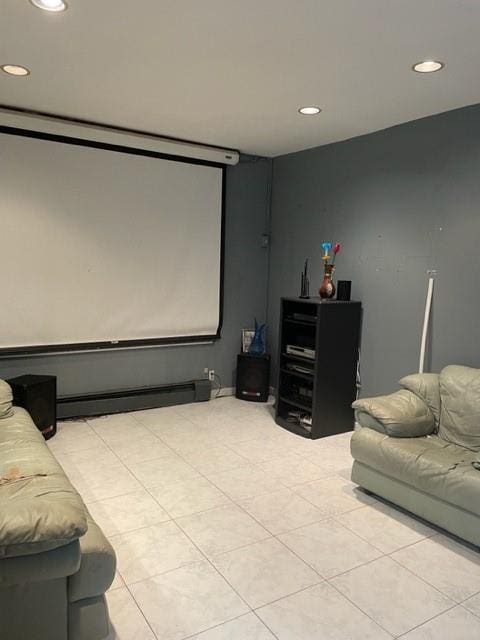 cinema room with a baseboard radiator and light tile patterned floors