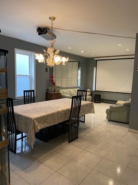 tiled dining room featuring a chandelier