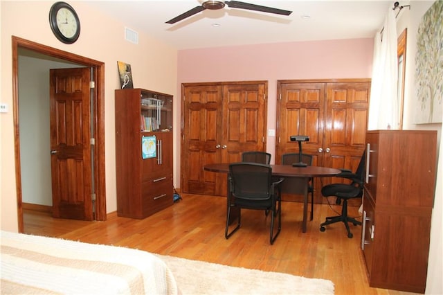 home office with ceiling fan and light wood-type flooring