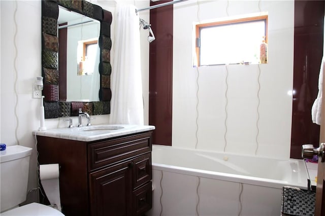 full bathroom featuring vanity, shower / tub combo, and toilet