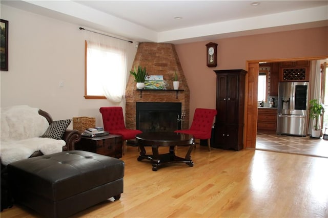 living room with hardwood / wood-style flooring and a large fireplace