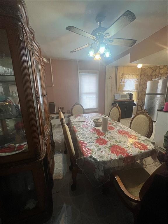 dining space with radiator and ceiling fan