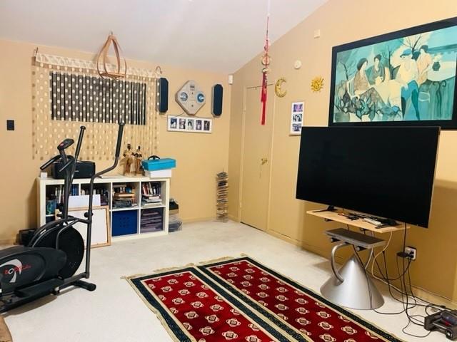 interior space featuring lofted ceiling and carpet flooring