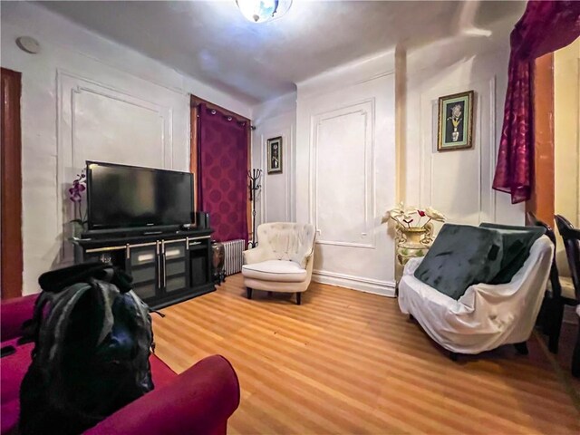 living room with hardwood / wood-style flooring and radiator