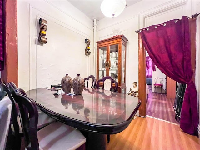 dining area featuring wood-type flooring