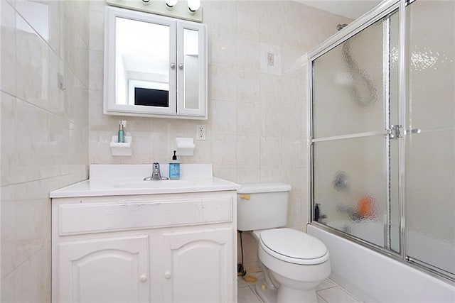 full bathroom featuring toilet, tile walls, vanity, enclosed tub / shower combo, and tile patterned flooring