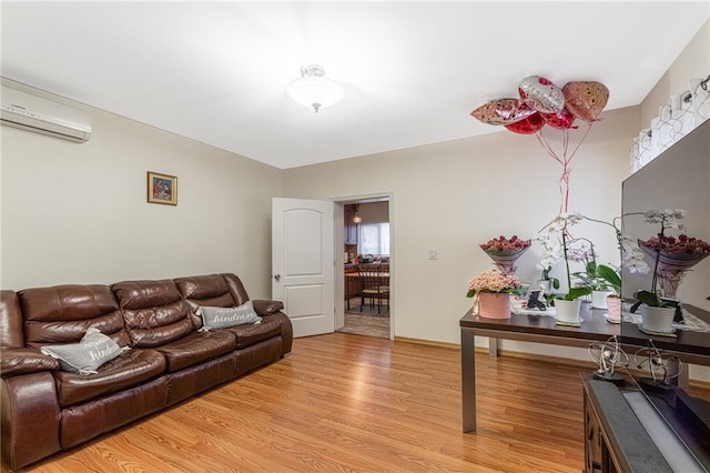 living room featuring hardwood / wood-style floors and a wall mounted AC